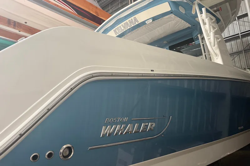 Slide: The Image of 2024 Boston Whaler 420 Outrage boat in a storage facility, showcasing sleek design. - 29