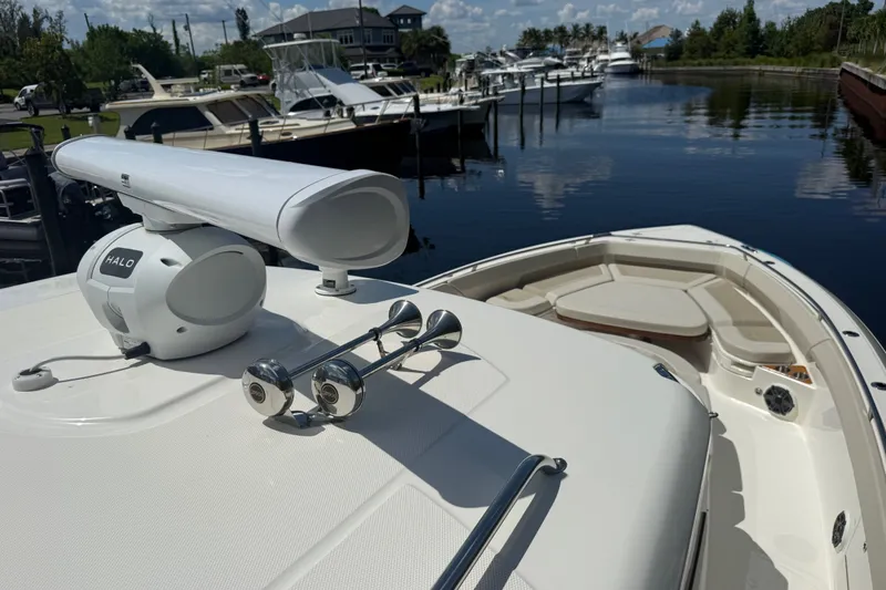 Slide: The Image of 2024 Boston Whaler 420 Outrage boat docked, featuring radar and spacious seating area. - 65