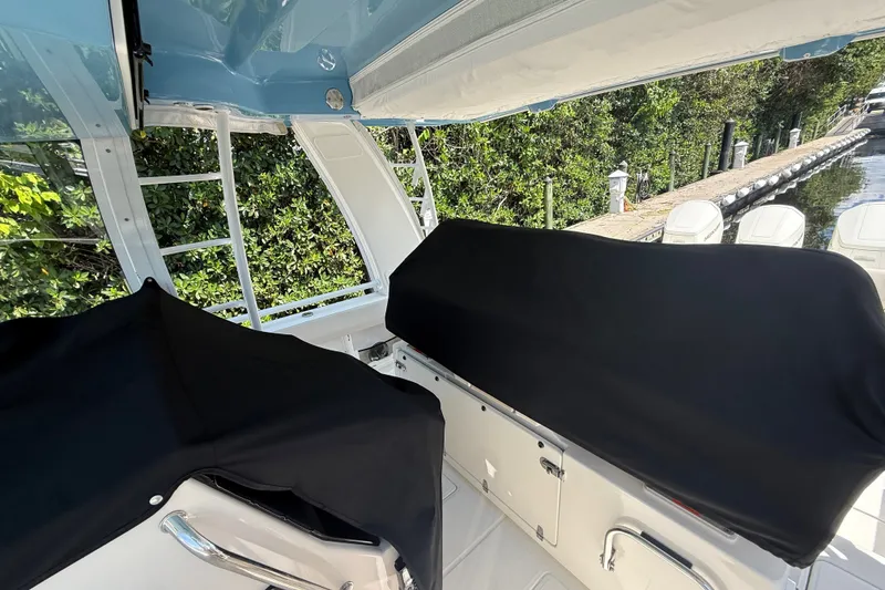 Slide: The Image of Interior view of 2024 Boston Whaler 420 Outrage boat with covered seating area. - 38