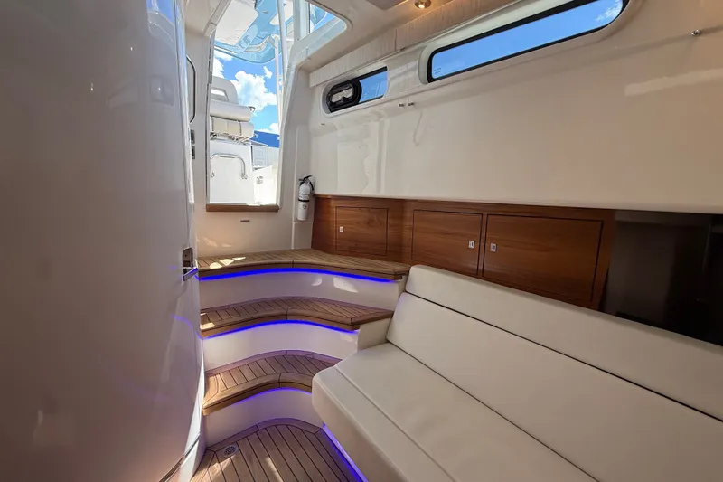 Slide: The Image of Luxurious interior of 2024 Boston Whaler 420 Outrage with elegant seating and ambient lighting. - 77