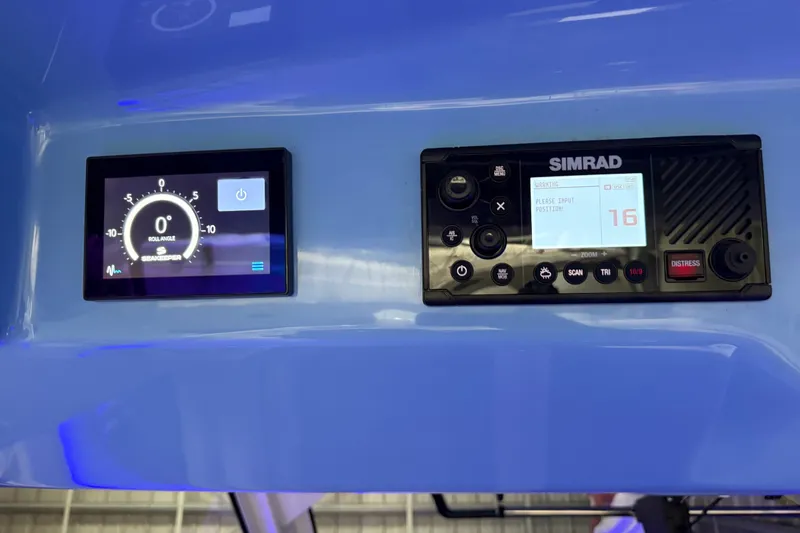 Slide: The Image of Control panel of 2024 Boston Whaler 420 Outrage with Simrad navigation system. - 13