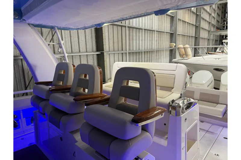 Slide: The Image of 2024 Boston Whaler 420 Outrage interior with luxurious seating and modern design. - 18
