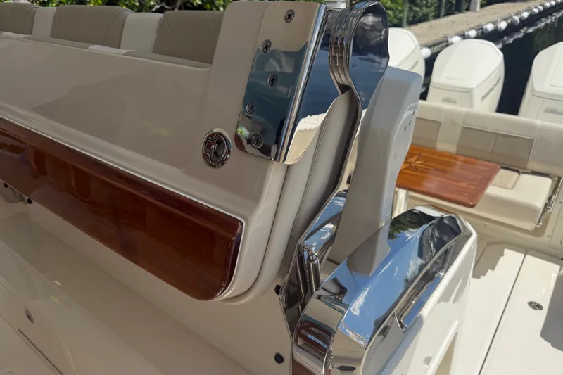 Slide: The Image of 2024 Boston Whaler 420 Outrage boat interior with polished chrome and wood accents. - 69