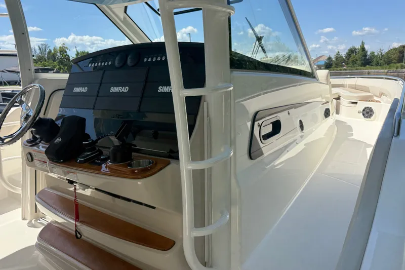 Slide: The Image of 2024 Boston Whaler 420 Outrage helm with Simrad electronics and sleek design. - 46