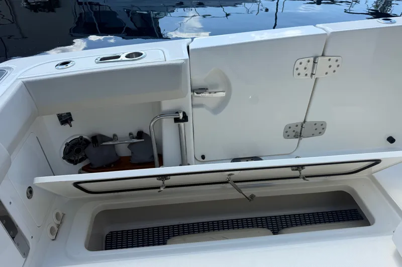Slide: The Image of 2024 Boston Whaler 420 Outrage boat storage compartments and utility area. - 54