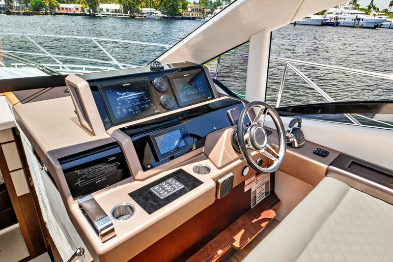 Slide: The Image of Helm of 2017 Galeon 560 Sky yacht with modern navigation controls and steering wheel. - 24