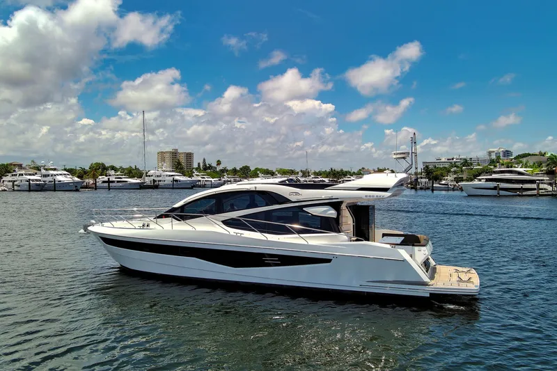 Slide: The Image of 2017 Galeon 560 Sky yacht on a sunny marina with blue skies. - 1