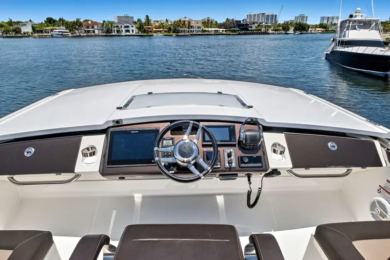 Slide: The Image of Helm of 2017 Galeon 560 Sky yacht with modern controls and waterfront view. - 10