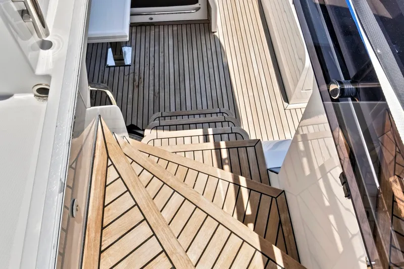 Slide: The Image of Wooden deck stairs on a 2017 Galeon 560 Sky yacht, showcasing elegant design. - 9