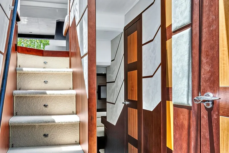 Slide: The Image of Interior staircase of 2017 Galeon 560 Sky yacht with modern wood paneling. - 25