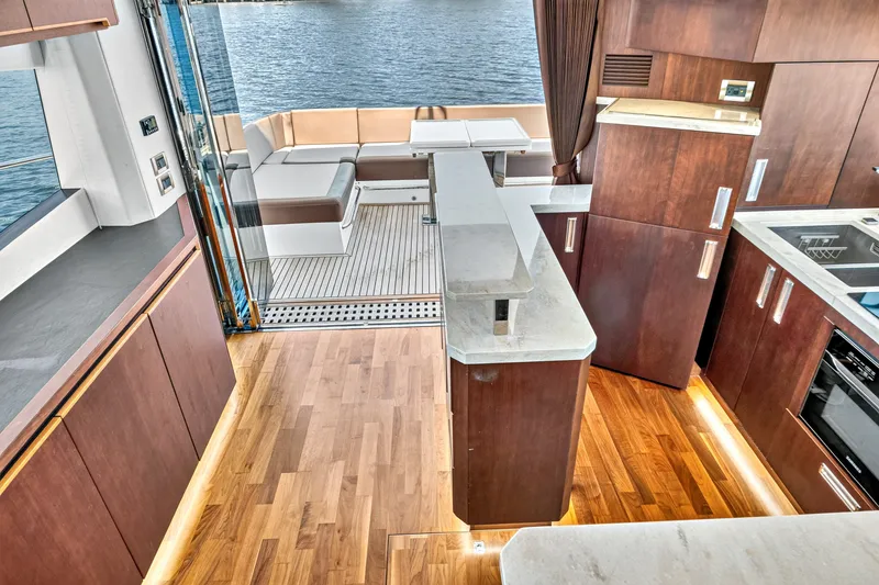 Slide: The Image of Luxurious interior of 2017 Galeon 560 Sky yacht with modern kitchen and seating area. - 17