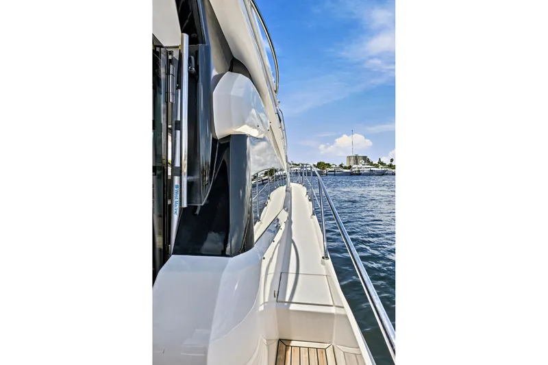 Slide: The Image of Side view of 2017 Galeon 560 Sky yacht on calm water under blue sky. - 12
