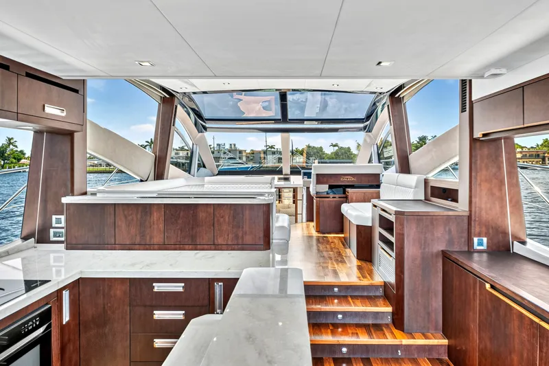 Slide: The Image of Luxurious interior of 2017 Galeon 560 Sky yacht with modern wood finishes and panoramic windows. - 15