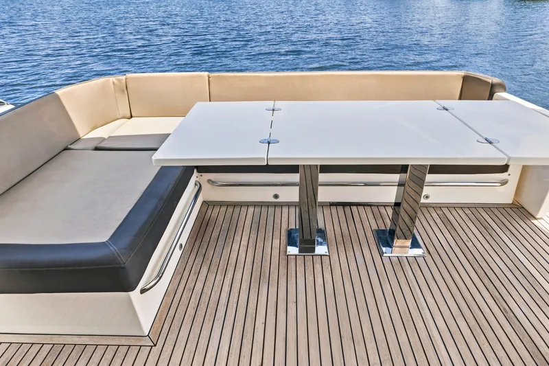Slide: The Image of Luxury seating area on 2017 Galeon 560 Sky yacht with sleek table and water view. - 8