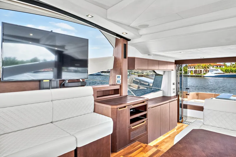 Slide: The Image of Luxurious interior of 2017 Galeon 560 Sky yacht with modern furnishings and waterfront view. - 16