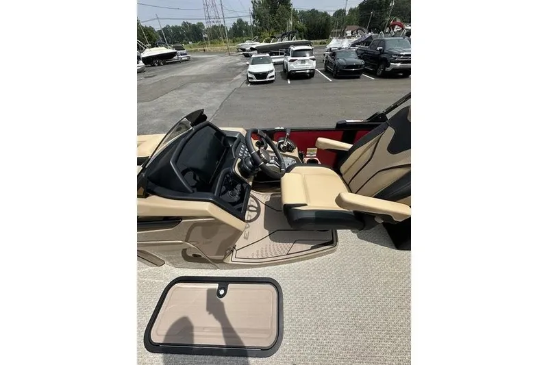 Slide: The Image of Interior view of 2026 Evotti 723QL boat with beige seating and control panel. - 21