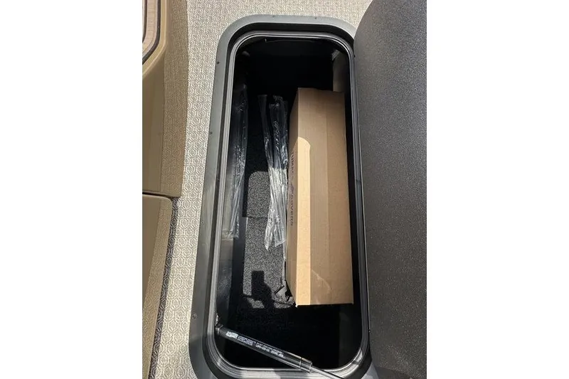 Slide: The Image of Storage compartment of 2026 Evotti 723QL with cardboard box and plastic-wrapped items. - 26