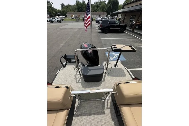 Slide: The Image of Evotti 723QL 2026 boat with American flag, parked in lot, beige seating, and motor. - 31