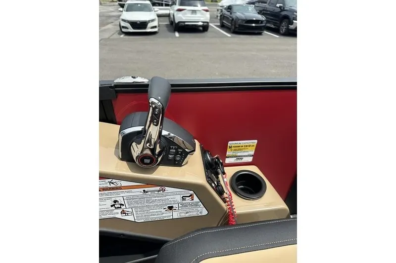 Slide: The Image of Control panel of 2026 Evotti 723QL boat with throttle lever and cup holder. - 7
