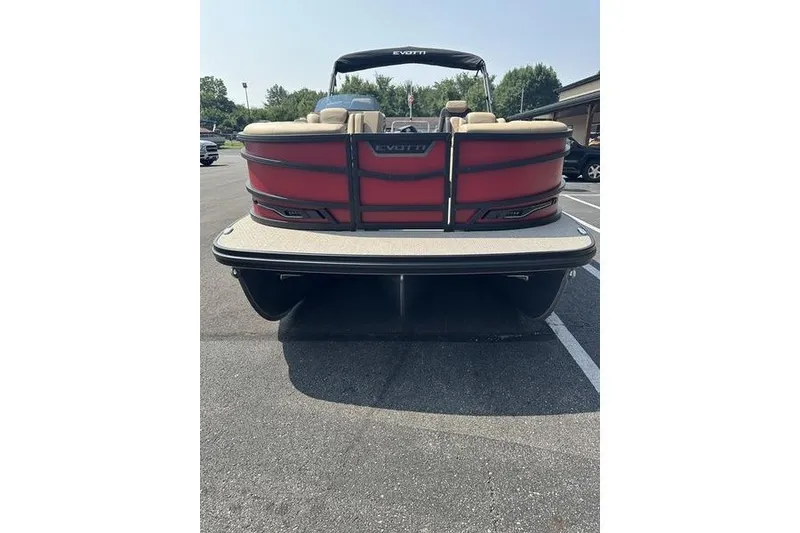 Slide: The Image of Red 2026 Evotti 723QL pontoon boat parked in a lot, rear view. - 22