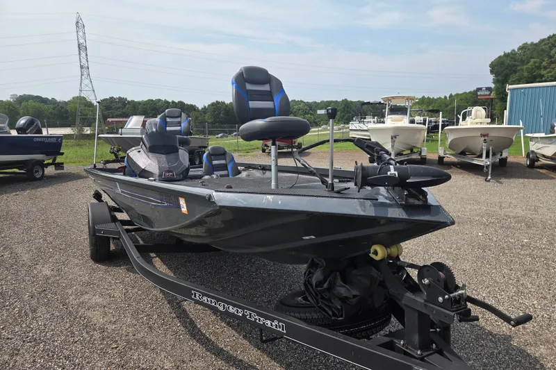 Slide: The Image of 2022 Ranger RT188 fishing boat on trailer, parked outdoors with other boats nearby. - 2