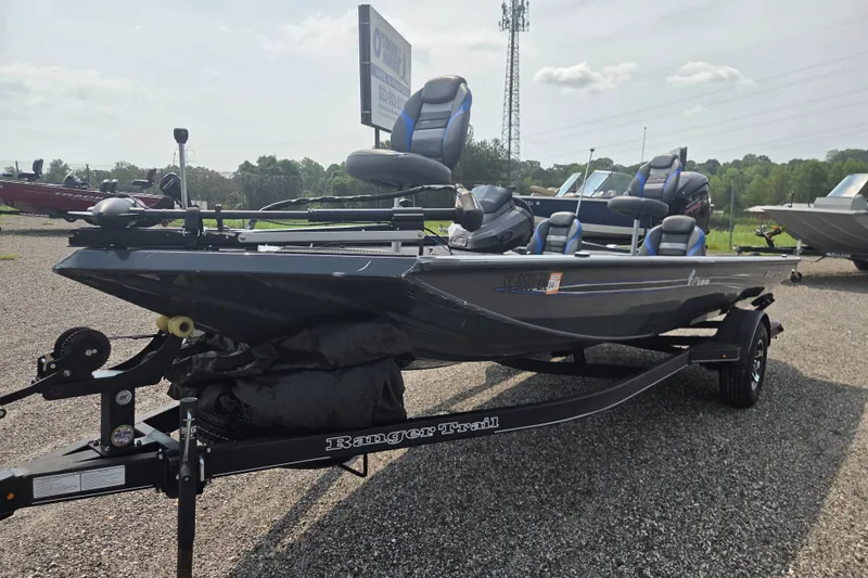 Slide: The Image of 2022 Ranger RT188 fishing boat on trailer, parked outdoors, featuring blue and black seating. - 4