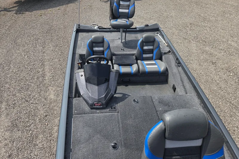 Slide: The Image of 2022 Ranger RT188 boat interior with blue and gray seating, steering console, and carpeted deck. - 13