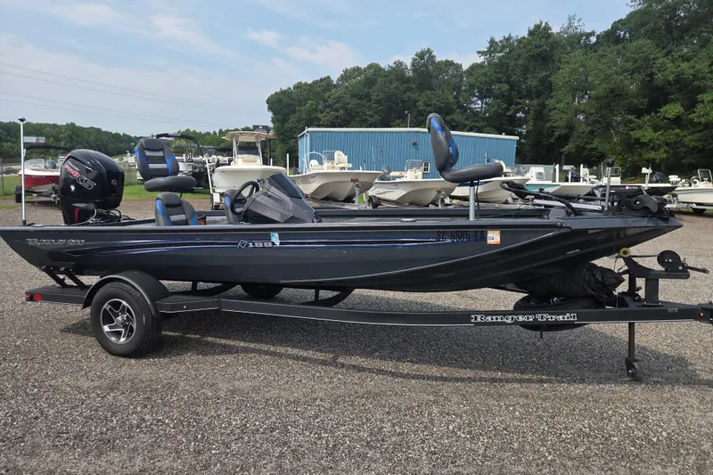 The Image of 2022 Ranger RT188 boat on trailer, parked outdoors near other boats. - 0