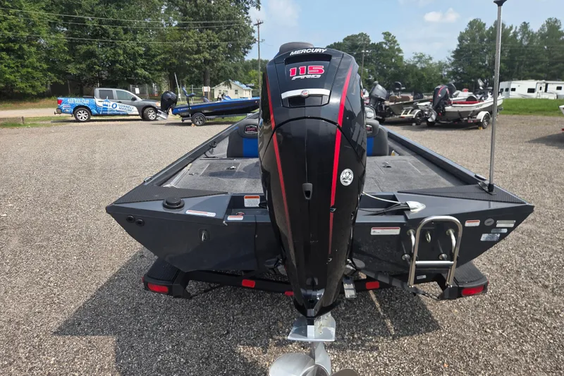 Slide: The Image of 2022 Ranger RT188 boat with Mercury 115 engine, parked outdoors on gravel. - 6