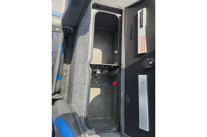Slide: The Image of Interior storage compartment of 2022 Ranger RT188 boat, featuring organized space and secure latch. - 11