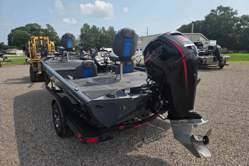 Slide: The Image of 2022 Ranger RT188 boat with powerful outboard motor, parked on gravel lot. - 7