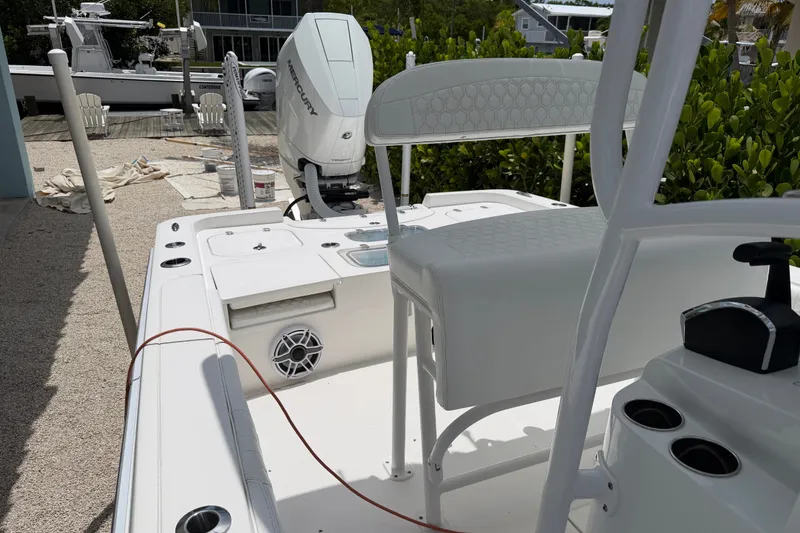 Slide: The Image of 2024 Contender 25 Bay boat interior with Mercury engine, featuring seating and control panel. - 39