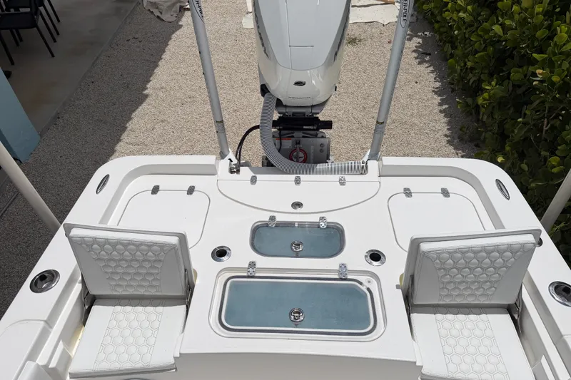 Slide: The Image of 2024 Contender 25 Bay boat deck with seating and storage compartments. - 36