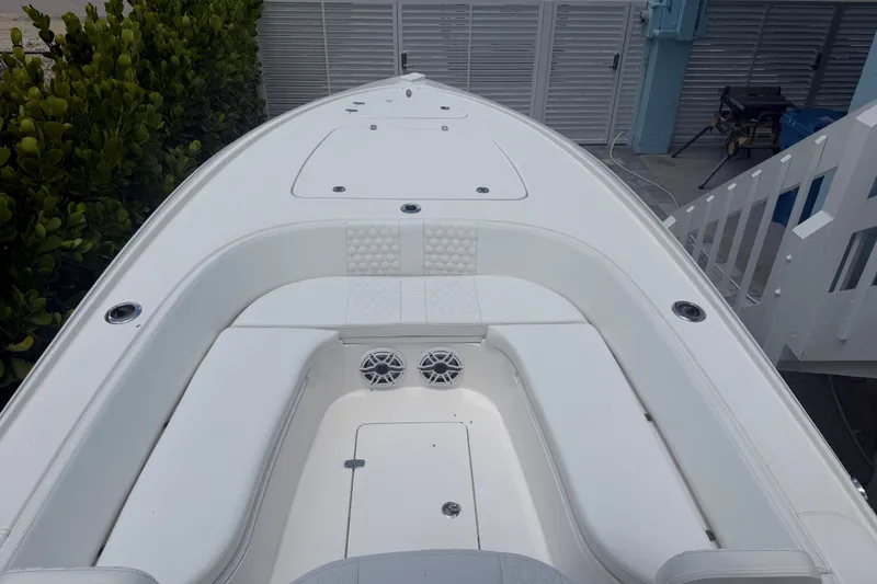 Slide: The Image of 2024 Contender 25 Bay boat interior with white seating and modern design. - 37