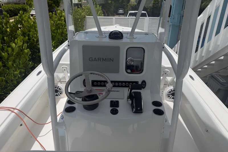Slide: The Image of 2024 Contender 25 Bay boat console with Garmin navigation system and steering wheel. - 38