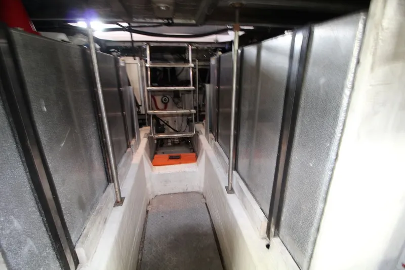 Slide: The Image of Engine room of 2000 Carver 530 Voyager Pilothouse with metal panels and ladder. - 42