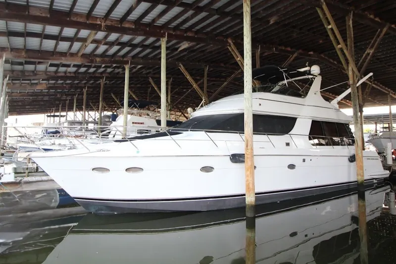 The Image of 2000 Carver 530 Voyager Pilothouse yacht docked in a covered marina. - 0