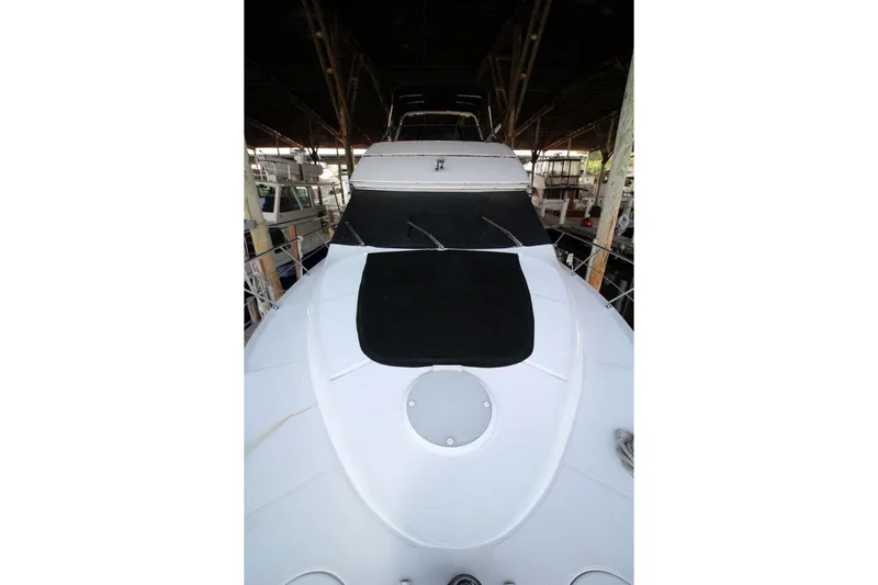 Slide: The Image of 2000 Carver 530 Voyager Pilothouse yacht docked in a covered marina. - 10