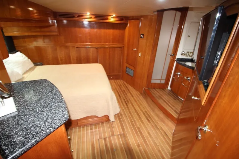 Slide: The Image of Luxurious interior of 2000 Carver 530 Voyager Pilothouse with wood paneling and cozy bed. - 29
