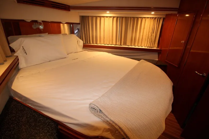 Slide: The Image of Luxurious bedroom interior of 2000 Carver 530 Voyager Pilothouse yacht with cozy bedding. - 37