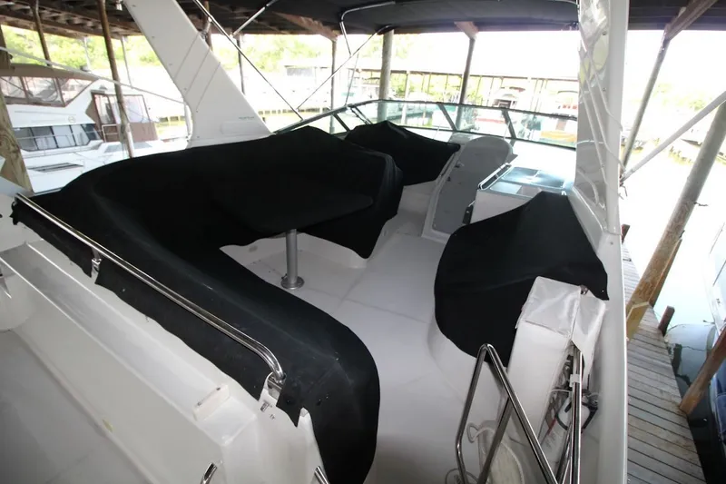 Slide: The Image of 2000 Carver 530 Voyager Pilothouse interior with covered seating and helm under a canopy. - 12