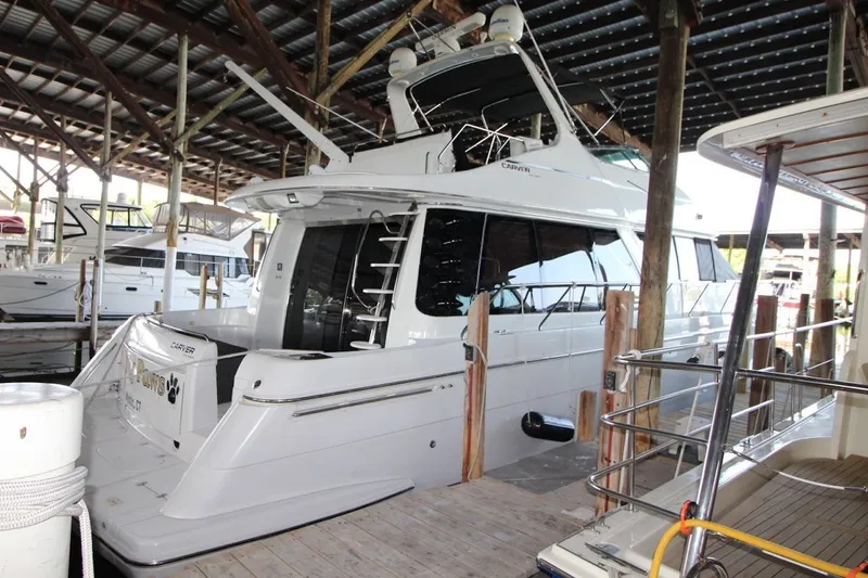Slide: The Image of 2000 Carver 530 Voyager Pilothouse yacht docked in a covered marina. - 3