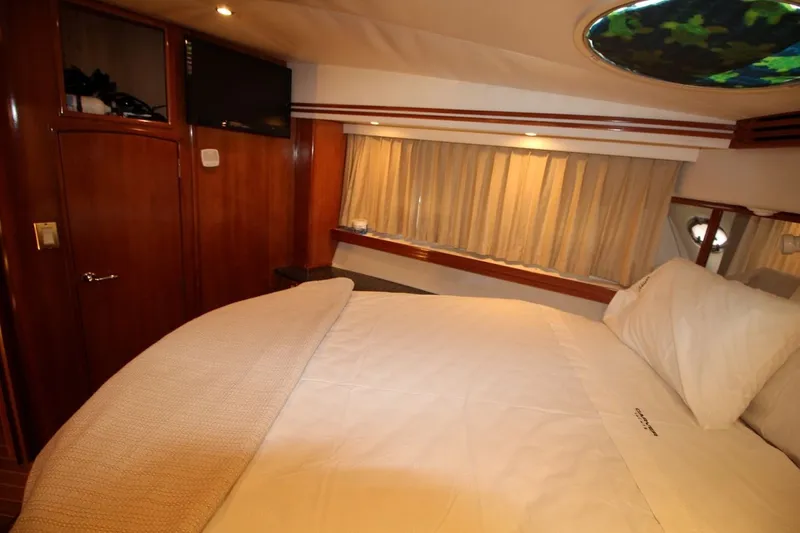 Slide: The Image of Luxurious bedroom interior of 2000 Carver 530 Voyager Pilothouse yacht with cozy bedding. - 38