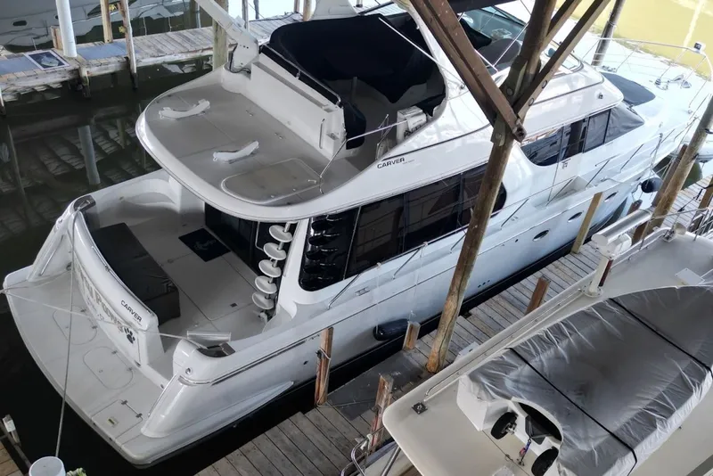 Slide: The Image of 2000 Carver 530 Voyager Pilothouse yacht docked in a marina, aerial view. - 7