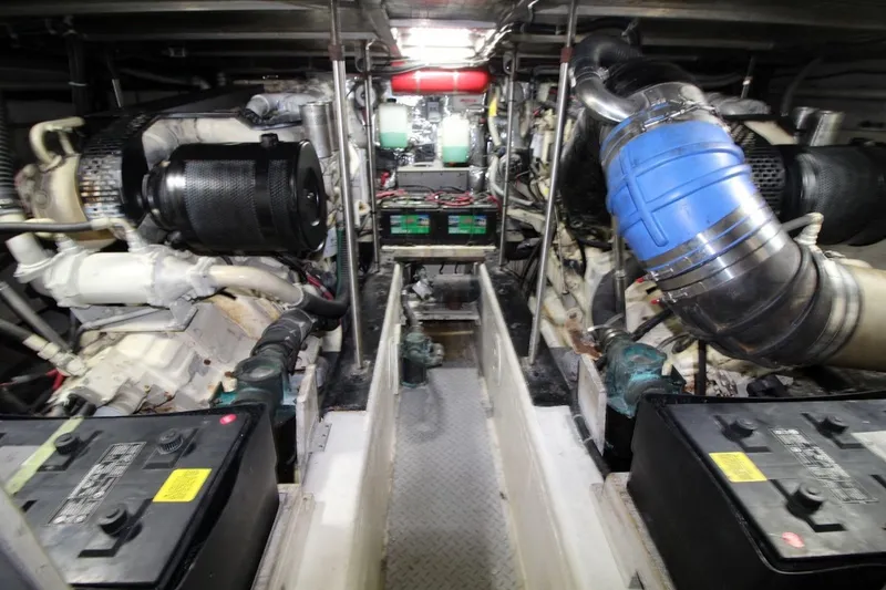 Slide: The Image of Engine room of a 2000 Carver 530 Voyager Pilothouse, showcasing mechanical components and batteries. - 39