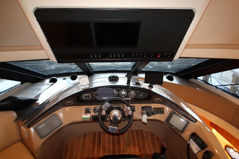Slide: The Image of Pilothouse interior of 2000 Carver 530 Voyager, featuring steering wheel and navigation controls. - 24