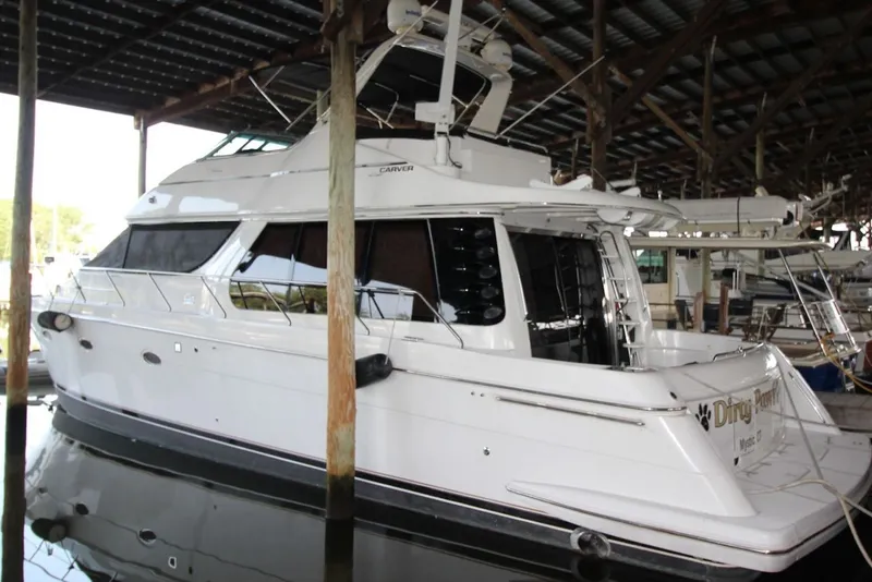 Slide: The Image of 2000 Carver 530 Voyager Pilothouse yacht docked in a covered marina. - 2