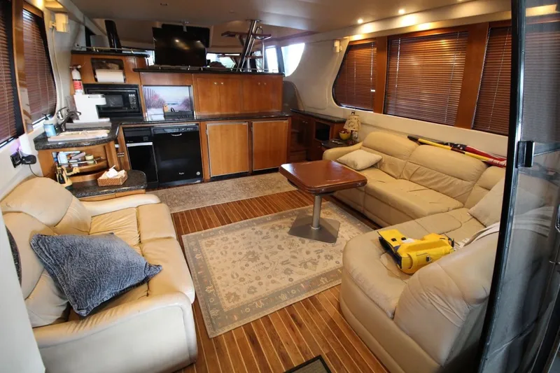 Slide: The Image of Luxurious interior of 2000 Carver 530 Voyager Pilothouse with leather seating and wooden cabinetry. - 18