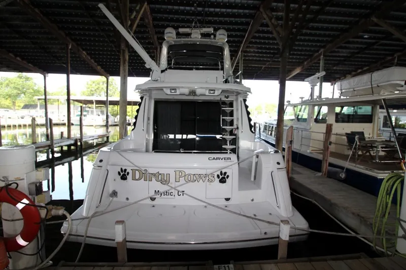 Slide: The Image of 2000 Carver 530 Voyager Pilothouse docked in a marina, rear view. - 4