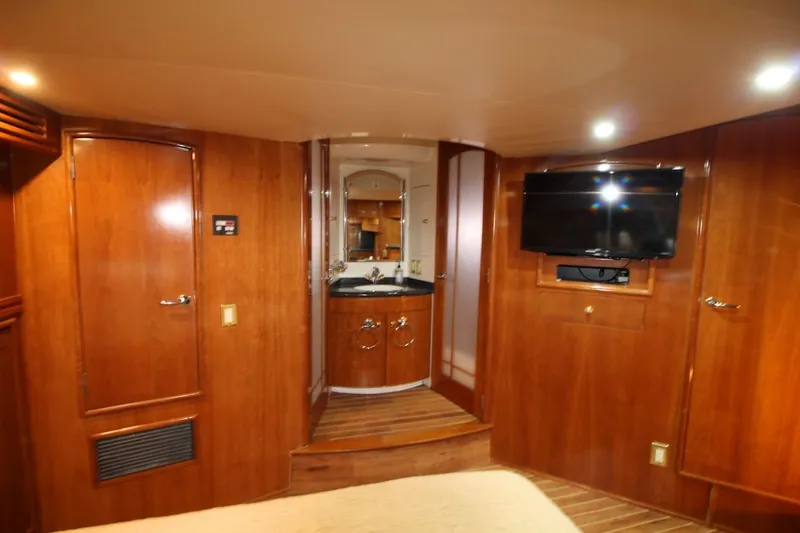 Slide: The Image of Luxurious interior of 2000 Carver 530 Voyager Pilothouse with wood paneling and mounted TV. - 32